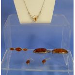 A small collection of modern Amber, including a Celtic style pendant on trace chain mounted in