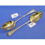 A near matched pair of George III silver Serving Spoons, one by Charles Hougham, hallmarked