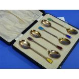 A George V set of six silver gilt and coloured enamel Coffee Spoons, by Joseph Gloster Ltd,