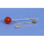 Three Stickpins, one with small circular finial and diamond point set star all in yellow metal,