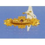 A 9ct yellow gold Bar Brooch of plaque shaped form, the centre set small ruby and four seed