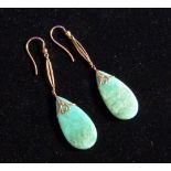 A pair of teardrop Pendant Earrings in mottled green jadeite, mounted in rose gold, in fitted case.