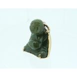 A jade Charm, in the form of a sitting Budda, his back covered in yellow metal with Chinese