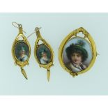 A Brooch and matchings Earrings,  the oval ceramic centres painted with Italian peasants, and each