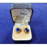 A pair of Earrings set with lapis lazuli oval centres and with yellow gold mount with rope work