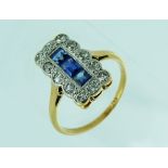 An attractive c.1920 Dress Ring, the oblong front set with three millegrain set calibre sapphires,