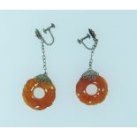 A pair of carnelian open circle carved Earrings, with filigree mounts, screw fittings in white