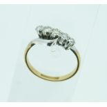 A five stone diamond Ring, set on the cross and mounted in 18ct white gold with yellow gold shank,
