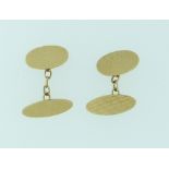 A pair of oval 9ct yellow gold double Cufflinks, with engine turned decoration, with chain