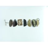 A Starborn Bracelet, set with seven large variously shaped plaques of shell, quartz and agates, with