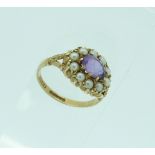 An antique oval amethyst and seed pearl ring, set in 9ct yellow gold, Size K½.