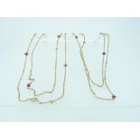 A long fine link Chain, set with ten small round ruby beads and thirty nine small seed pearls, the