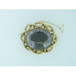 An attractive large oval Brooch, set with a white plaque applied with a hair set wheat sheaf, tied