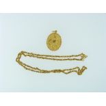 A Chinese yellow gold oval Pendant, with ropework border, the front with flowers, leaves and an