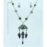 An Oriental Necklace, the sterling silver chain set with green and mauve beads, suspending an