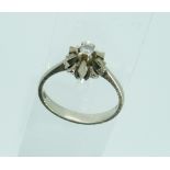 A white gold Ring, the front set with flowerhead form, the centre with small single diamond c.1/8,