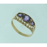 A 9ct yellow gold Ring, set with three pale amethysts and diamond points, Size M.