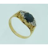 An 18ct yellow gold Ring, mounted with an oval sapphire, c.1¼ct., with three diamond points on the