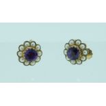 A pair of circular seed pearl and amethyst centred Earrings, with screw fittings in 9ct yellow