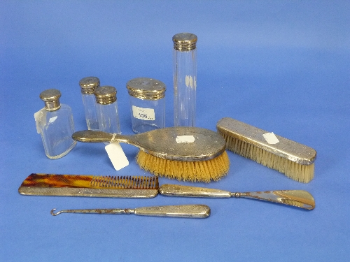 A George V ten-piece silver-mounted Toilet Set, hallmarked London, 1910-1913, with engine-turned