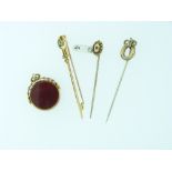 Three Gentleman's Stickpins, two in yellow gold marked 15ct, the other unmarked, one set with