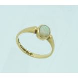 A small 18ct yellow gold Ring, set with oval cabochon opal (stone chipped), Size L.