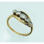 A graduated five stone diamond Ring, with rubbed over settings, set on the cross in an 18ct yellow
