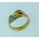 A double headed snake Ring, the front with one head set turquoise with garnet eyes, the other set