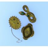 Three gilt metal Brooches,  one formed of a coiled snake head set with green stone,garnet eyes and a