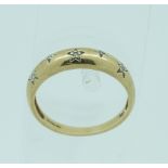 A 9ct yellow gold plain Ring, gypsy set with five small diamond point, Size O.