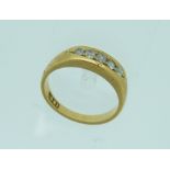 An 18ct yellow gold Ring, set with five small brilliant cut diamonds, Size M.
