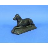 An early 20thC bronze Hound Dog, seated on shaped oval base, 8in (20.25cm) high. THIS LOT WILL BE