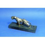 An early 20thC silver-plated bronze figure of a Jaguar, in crouching attitude, on black slate