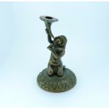 A late 19thC continental bronze Candlestick, modelled as a kneeling boy on circular base, 5½in (