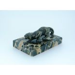 An Art Deco silvered bronze Panther Paperweight, in crouching attitude, on marbled rectangular base,