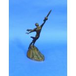 A Russian Art Deco bronze figure of a nude, he with drapes in flight pose and holding onto a rocket,