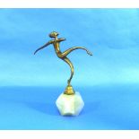 An Art Deco stylised bronze figure of a Dancer, with scrolled limbs, on hexagonal base and canted