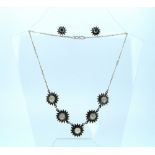 A silver Necklace and matching Earrings,  the necklace with five multi-petalled flower heads, each