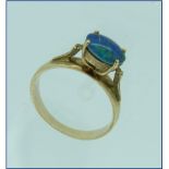 A single stone oval opal Ring, of good green/blue colour, mounted laterally, on a wide 9ct gold