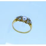 A diamond and cultured pearl Ring, the central half cultured pearl with three diamonds on each