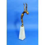 An Art Deco gilded spelter figure of a Nude, standing with outstretched arms and arched back, on