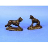 An early 20thC bronze Terrier, seated on shaped oval base, 4in (10cm) high, together with another