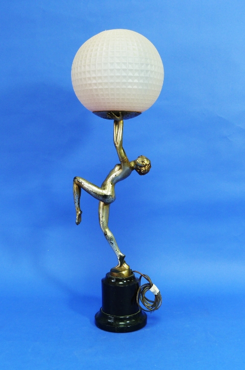 An Art Deco silvered spelter Danseuse Table Lamp, the nude dancer standing on one leg and holding