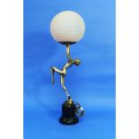An Art Deco silvered spelter Danseuse Table Lamp, the nude dancer standing on one leg and holding