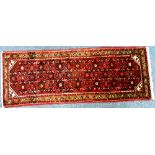 Tribal rugs; a Persian Hamadan runner, red-pink ground with all over stylized floral designs, set