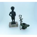 An early 20thC bronze figure of Manneken Pis, on square base, inscribed 'Bruxelles', overall 5½in (