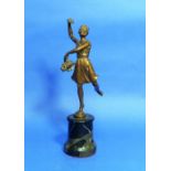 An early 20thC bronze figure of a Flower Girl, she standing dancing and holding a basket of flowers,