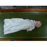 An Armand Marsaille bisque head Baby Doll, with moulded head, blue glass eyes and open mouth with