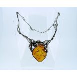 A modern silver and amber Necklace, formed of long silver bar links, the front with foliage and