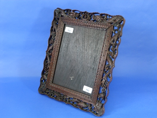 An Oriental carved hardwood easel Picture Frame, carved and pierced with dragons, fisg and lobster